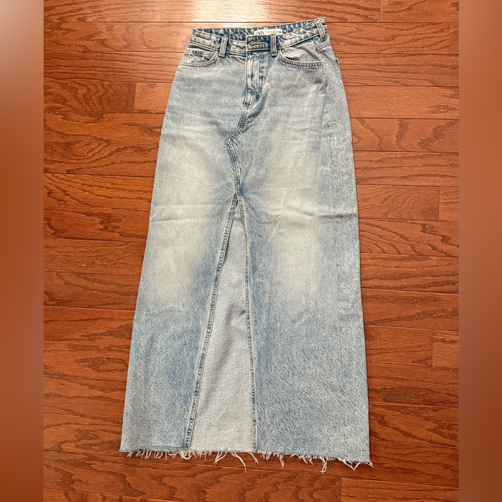 box of multiple items, skirts, dresses, swimsuits and yoga onesie.Aritzia&Skims+